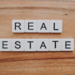 Real estate investing for beginners cover with a house, calculator, and key icons