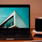 Real Estate Investing for Beginners cover with a notebook, calculator, house outline, and rent chart